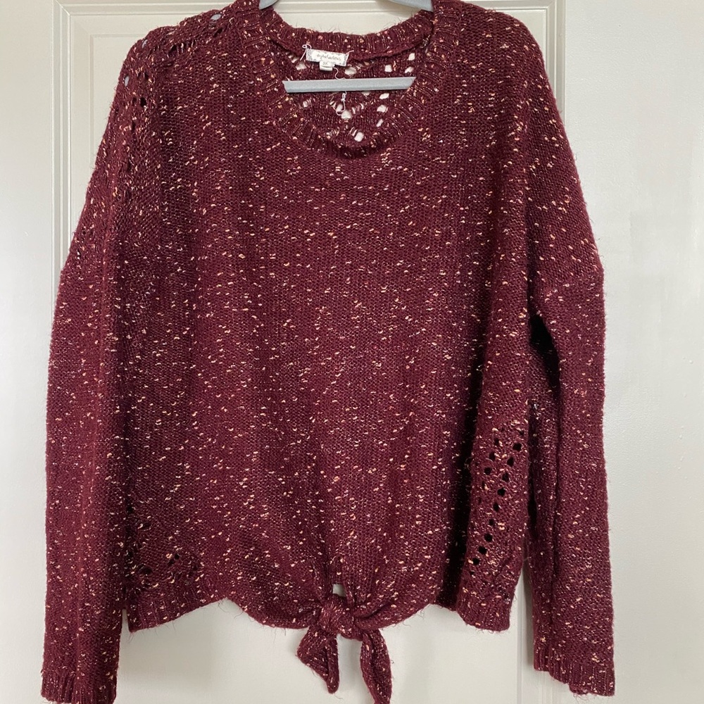 Maroon sweater with tie up accent and knit pattern